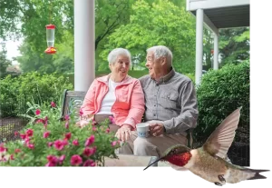 Couple in their garden with a hummingbird